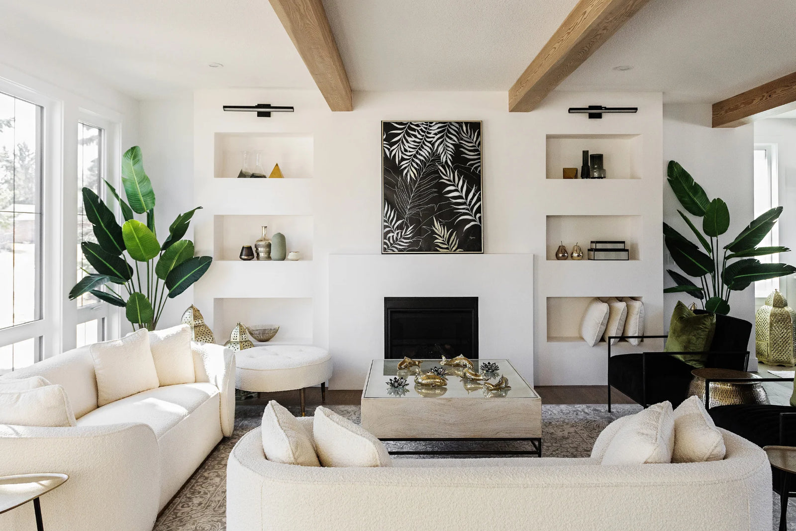 Living room white couches, white walls, and green plants